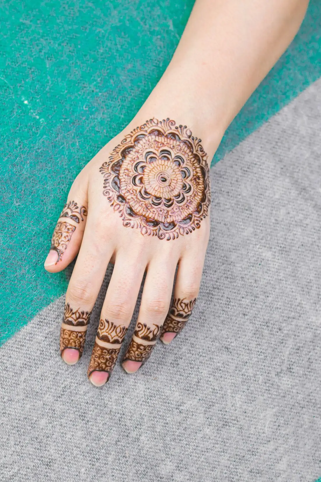 Bridal mehndi covering both palms in fine paisley work